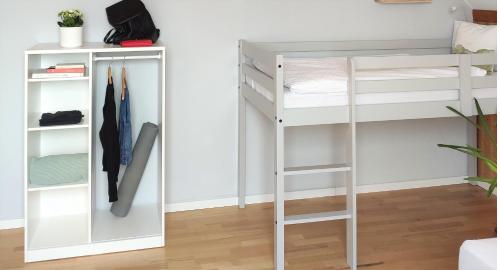 a bunk bed with a ladder next to a closet at Ferienhaus Erna in Doberlug-Kirchhain