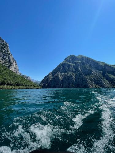 a view from a boat in the water with mountains in the background at Hotel Kompleksi Arifi in Shkodër