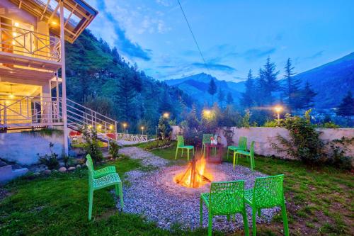 a fire pit in the yard of a house at Baan by Snow City Farm in Vashisht