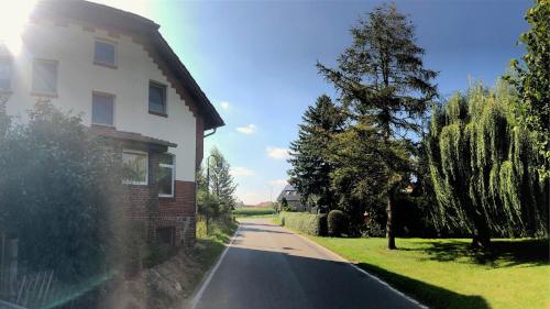 a house and a road next to a house at Ferienhaus Erna in Doberlug-Kirchhain