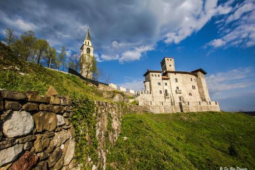 a castle on a hill with a stone wall at Al Castello in Artegna