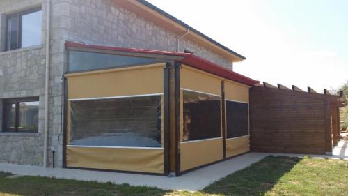 a building with a large glass door on the side of it at La Ola de Cantabria in Miengo