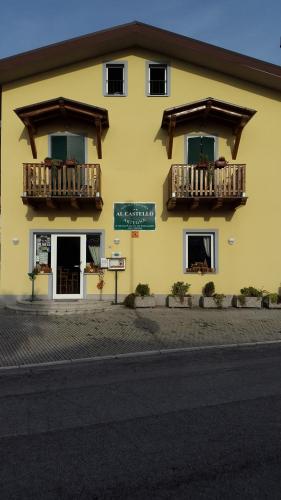 a yellow building with balconies on the side of it at Al Castello in Artegna