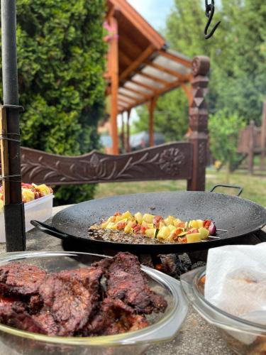 a grill with meat and vegetables on a table at Vénusz Üdülőcentrum in Tiszacsege