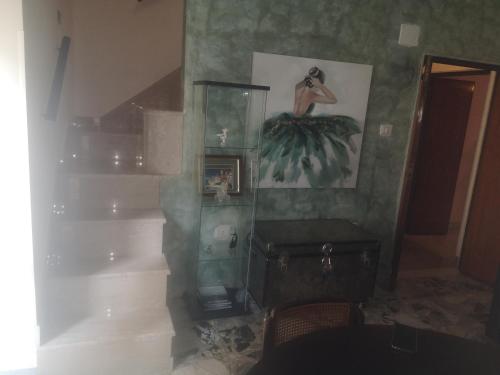 a room with a shelf and a picture of a bird on the wall at Casa vacanze Sofia in Irsina