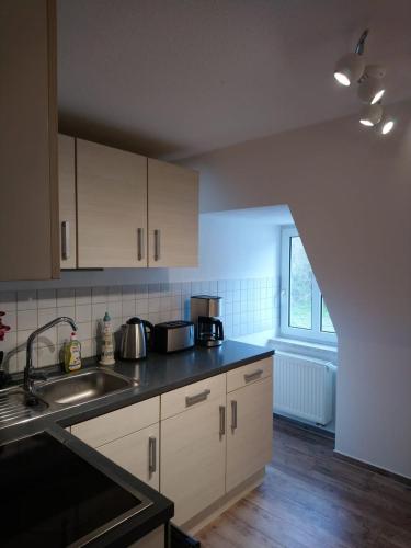 a kitchen with a sink and a counter top at FewoQuido 2 in Königsee