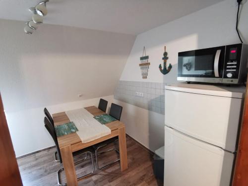 a small kitchen with a small table and a microwave at FewoQuido 2 in Königsee