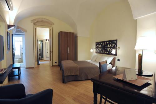 a bedroom with a bed and a desk in a room at Negramaro Suite B&B in Lecce