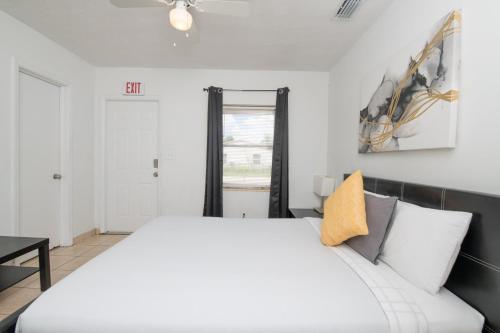 a bedroom with a white bed and a window at Hollywood private apartments in Hollywood