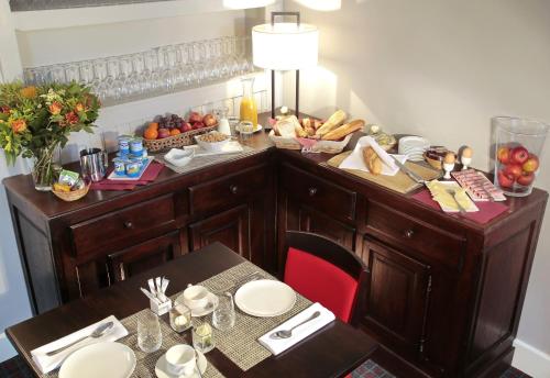 a table with a buffet with bread and fruit on it at Hotel Golf de Pierpont in Bons Villers