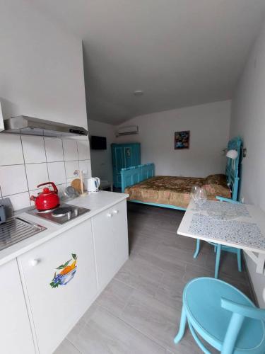 - une cuisine avec une table et un lit dans une chambre dans l'établissement apartman Vrdničak 2, à Vrdnik