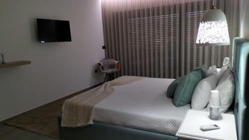 a bedroom with a bed and a table with a lamp at CRASTO PAYVA DOURO NATURE in Castelo de Paiva