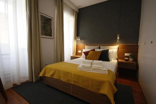 a bedroom with a bed with towels on it at Timeless Ambassador -Belém in Lisbon