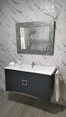 a bathroom with a sink and a mirror at CRASTO PAYVA DOURO NATURE in Castelo de Paiva