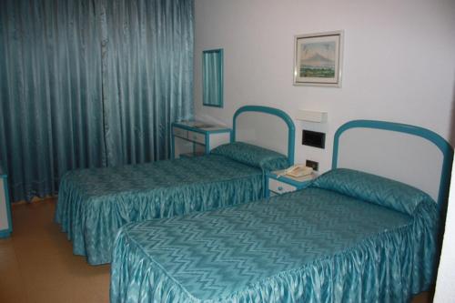 Säng eller sängar i ett rum på Hotel Playa Grande