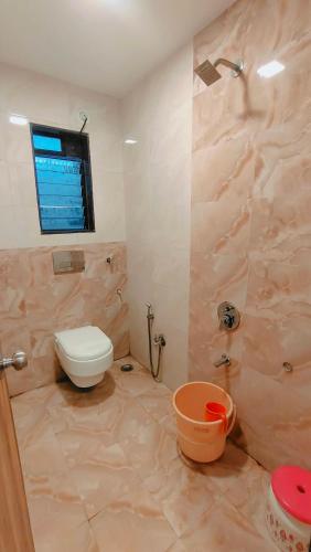 a bathroom with a toilet and a shower at Hotel Mari Aai Residency in Navi Mumbai