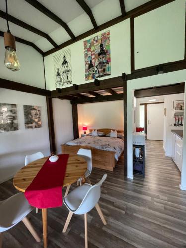 a bedroom with a bed and a wooden table and chairs at Ferienwohnung Studio 5 in Siegsdorf