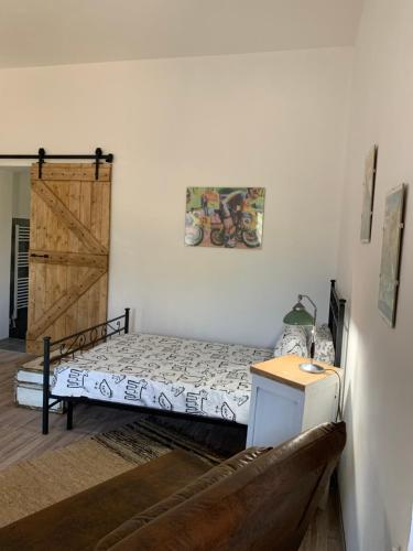 a bedroom with a bed and a wooden door at Cà del Prete country room in Valenza