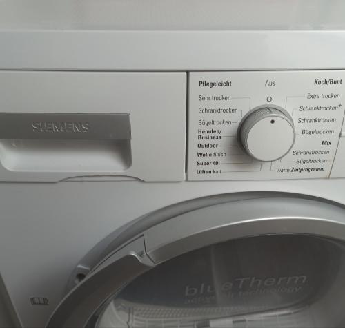 a close up of a washing machine with its door open at Apartment 28 in Stadthagen