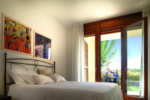 a bedroom with a bed and a sliding glass door at Chianti Village Morrocco in Tavarnelle in Val di Pesa