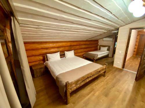 a bedroom with a bed and a wooden ceiling at Complex MAYARIV in Makariv