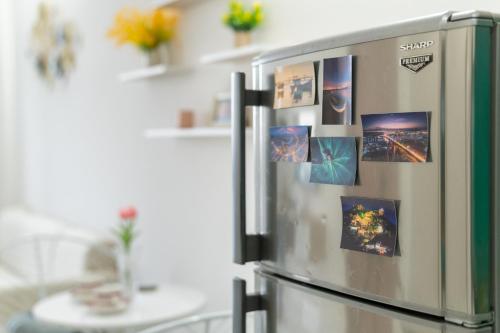 a refrigerator with pictures on it in a kitchen at Trang Dream House Phan Rang in Kinh Dinh