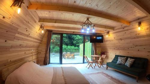 1 dormitorio en una cabaña de madera con 1 cama y 1 mesa en Hayde Bungalow, en Çamlıhemşin