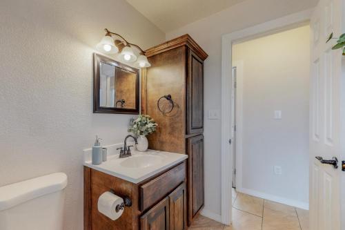 a bathroom with a sink and a mirror at Comfortable 3-bedroom home with spacious backyard in Albuquerque