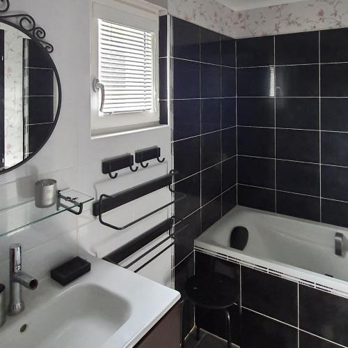 a bathroom with a sink and a bath tub at Le bois de l'étang - Gîte 3 étoiles - 6 pers in Faramans