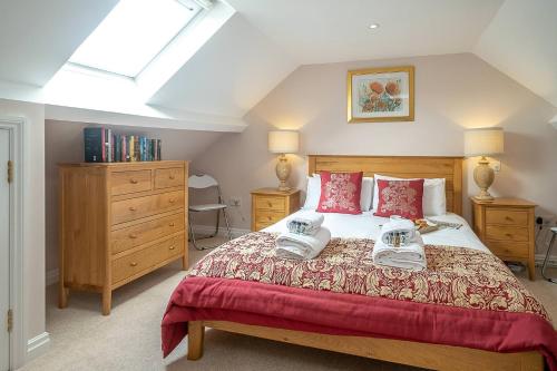 a bedroom with a bed with two shoes on it at The Haven at Coastguard Court - Aldeburgh Coastal Cottages in Aldeburgh