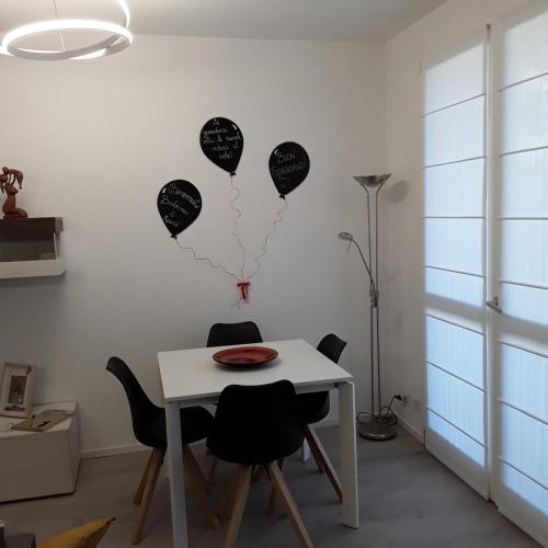 a table and chairs with balloons on the wall at OLTRE LE NUVOLE in Cuneo
