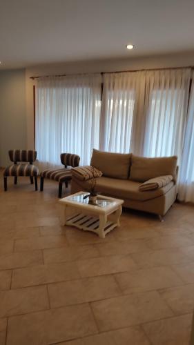 a living room with a couch and a coffee table at Hostería Magnolia in Villa Gesell