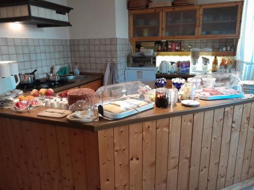 a kitchen with a counter with food on it at Pension Edelweiß in Kurort Gohrisch