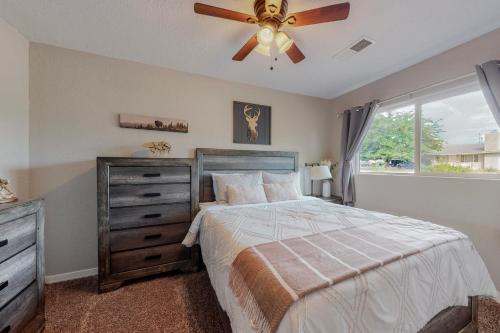 a bedroom with a bed and a ceiling fan at Comfortable 3-bedroom home with spacious backyard in Albuquerque