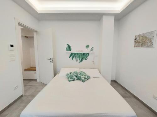 a white bedroom with a large white bed in it at La Gardenia in Celano