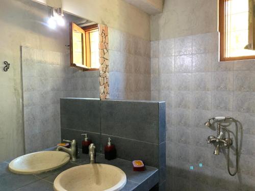 a bathroom with a sink and a shower at Kyparissi Guest House in Paralía Kiparissi