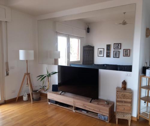 a living room with a large flat screen tv at Sea view Penthouse with beautiful Terrace - Casa Verdi Jayanti in Lido di Ostia