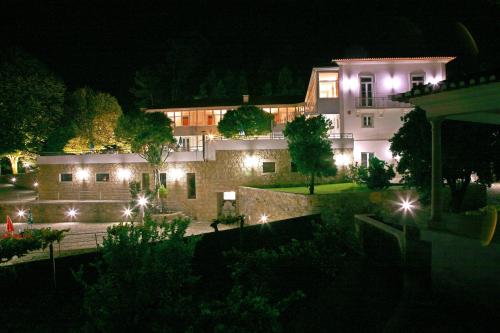 a building with lights in front of it at night at Hotel Quinta Progresso in Macieira de Cambra