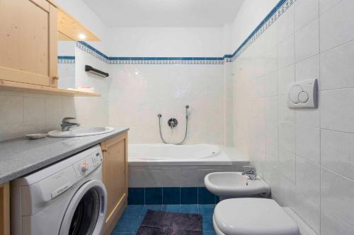 a bathroom with a sink and a washing machine at Casa Rododendro - Cavalese Dolomites in Cavalese