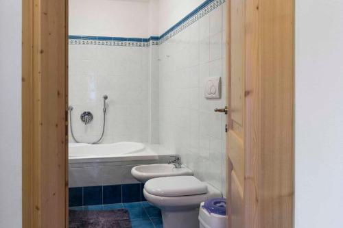 a bathroom with a toilet and a bath tub at Casa Rododendro - Cavalese Dolomites in Cavalese