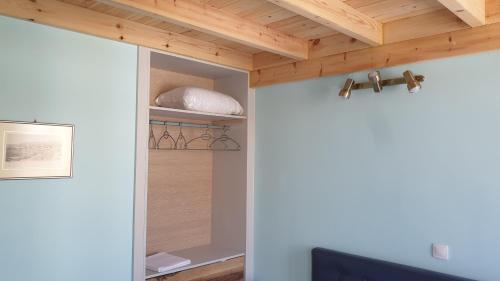 a room with a closet with a wooden ceiling at Christos Katerina House in Pythagoreio