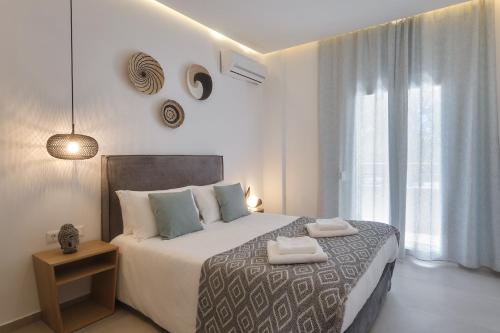 a bedroom with a bed with two towels on it at Heliotopos in Skala Eresou
