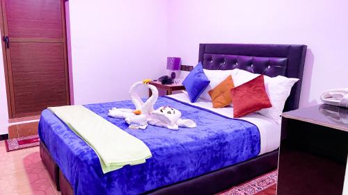 two stuffed animals are sitting on a bed at Hotel EL MARSA LA PLAYA in Laayoune