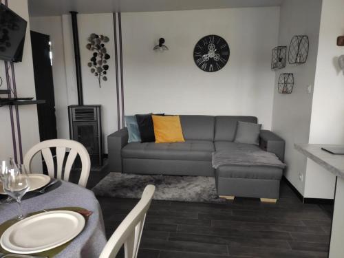 a living room with a couch and a table at Appartement cosy centre-ville wifi parking in Charleville-Mézières