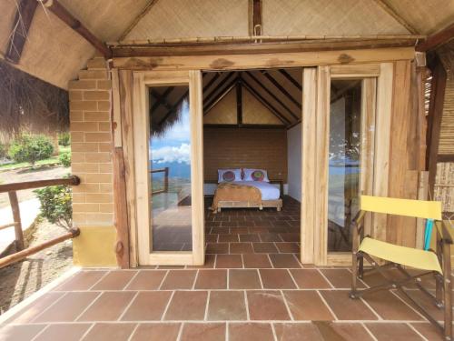 a room with a bed on a patio at Hotel Cariguá in Barichara