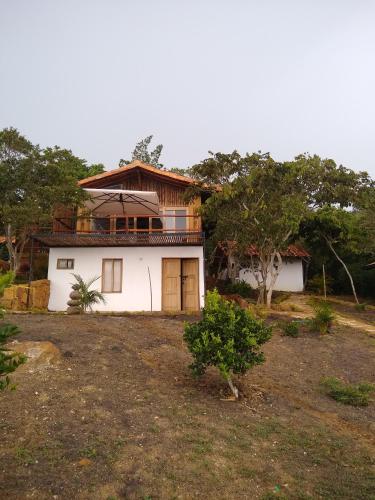 a house in the middle of a field at Hotel Cariguá in Barichara