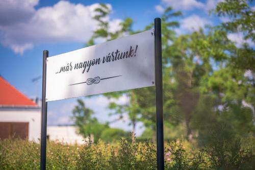 a white sign with the words autism therapy nethello at Hercegasszony Birtok in Mezőtúr