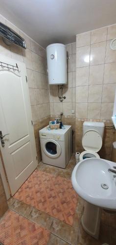 a small bathroom with a toilet and a sink at Apartman Dada in Bijeljina