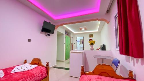 a room with a bed and a pink ceiling at Hotel EL MARSA LA PLAYA in Laayoune