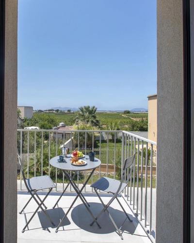 a patio with a table and chairs on a balcony at 18 Gradi Apartments in Marsala